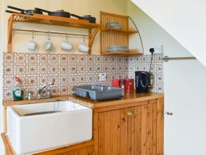 a kitchen with a sink and a counter top at Ty Mawr 1 - Uk36545 in Nantlle