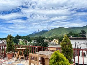 a balcony with a table and a view of mountains at Jireh guesthouse in Antigua Guatemala