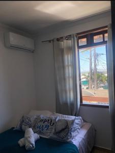 Ένα ή περισσότερα κρεβάτια σε δωμάτιο στο Suites e Quartos Em frente a Praia Grande -Na orla Flavia Alessandra