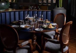 a table with glasses of wine and food on it at Grande Hotel Termas de Araxá in Araxá