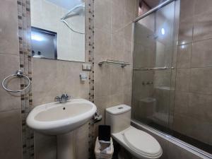 a bathroom with a sink and a toilet and a shower at Hotel San Miguel in Piura