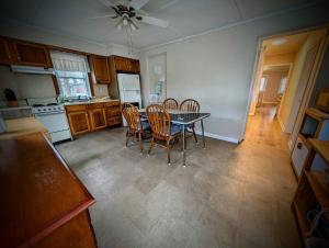 a kitchen with a dining room table and chairs at Ocean Breeze Retreat in Beach Haven +4 photos