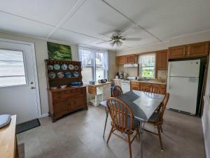 a kitchen with a table and chairs and a refrigerator at Ocean Breeze Retreat in Beach Haven