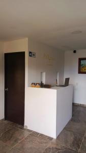 an office with a white counter with a laptop on it at Paraíso del Chicamocha in Aratoca