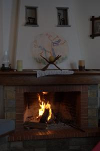 a fireplace with a globe on top of it at Vera's Traditional House in Zagora