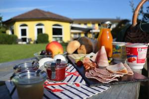 a picnic table with a plate of food and drinks at Fewo Seeanker in Friedrichskoog
