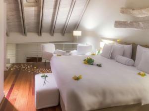 Voodi või voodid majutusasutuse Hotel Boutique Bovedas de Santa Clara By Accor toas