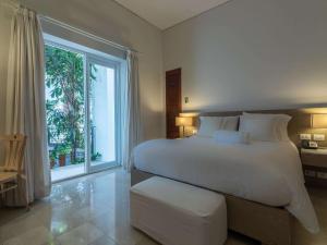 Voodi või voodid majutusasutuse Hotel Boutique Bovedas de Santa Clara By Accor toas