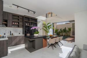 a kitchen with a large island in the middle of a room at Nidya Villa Canggu in Canggu
