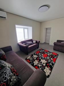 a living room with a couch and a rug at Сдаётся недалеко от озера в тихом уютном месте жилой дом in Balqash +21 photos