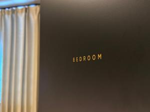 a close up of a laptop with the word bedoren on it at TABISAI HOTEL Luxe 博多 in Fukuoka +38 photos