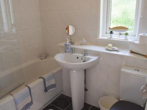 a bathroom with a sink and a toilet and a shower at Tree Tops in Crieff