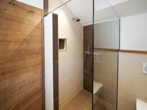 a shower with a glass door in a bathroom at Lapperhof in Waging am See +26 photos