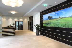 a hallway with a large window in a house at Hotel kommod in Ruggell