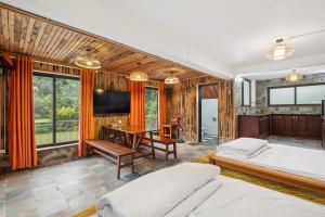 a bedroom with two beds and a desk at Villa Nhà Ba Gian Hoà Lạc in Nam Giao