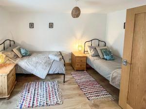 Postel nebo postele na pokoji v ubytování Willesdene Cottage