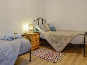 Postel nebo postele na pokoji v ubytování Willesdene Cottage