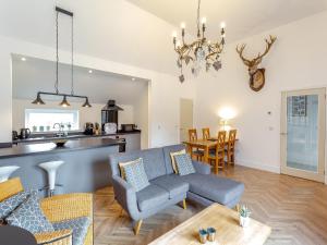 a living room with a couch and a table at Old School House in Altnaharra +17 photos