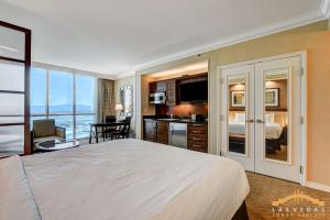 a bedroom with a large white bed and a kitchen at MGM Signature-22-604 Jacuzzi Studio in Las Vegas +45 photos