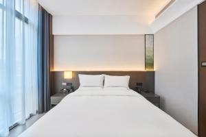 Rúm í herbergi á Beijing Suiyu Hotel
