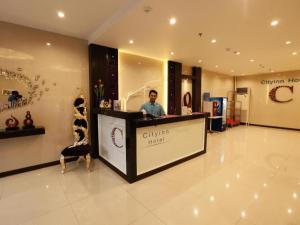 a man standing at a counter in a store at Cityinn Hotel in Zamboanga