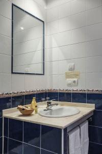 a bathroom with a sink and a mirror at Hotel Rural Suquin in Navia +108 photos