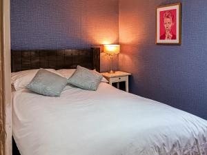 a bed with two pillows on it in a bedroom at Beach Oasis Cottage - Uk48530 in Margate