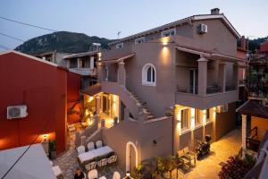 a view of a building with tables and chairs at Aurelia Suites in Benitses