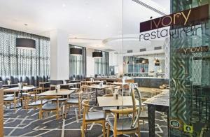 a dining room with tables and chairs and a restaurant at 1 Valentine Ave in Sydney