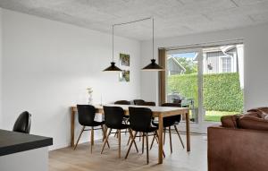 a kitchen and dining room with a table and chairs at 3 Bedroom Cozy Home In Tarm in Tarm