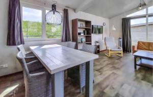 a living room with a white table and chairs at Cozy Home In Sint-Annaland With Wifi in Sint Annaland