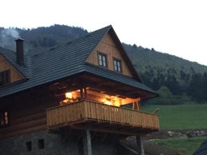 a large wooden house with a balcony on a hill at Drevenica u Michala in Terchová