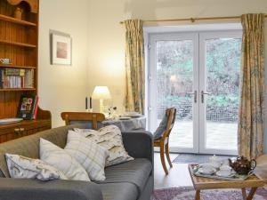 un salon avec un canapé et une table dans l'établissement Nettlebush Cottage-Uk5629, à Drummelzier