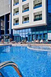 a large swimming pool in front of a building at Hotel Madeira Centro in Benidorm