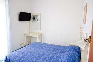 a bedroom with a blue bed and a tv at Mare Blu Residence in Martinsicuro