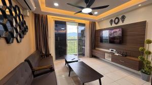 a living room with a table and a large window at Mentz Homestay in Papar