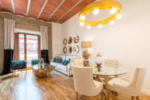 a living room filled with furniture and a table at BiBo Suites Oro del Darro in Granada