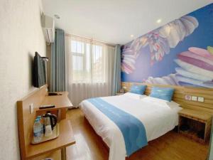 a bedroom with a bed with a fish painted on the wall at PAI Hotel Shijiazhuang Luquan Zoo in Luquan
