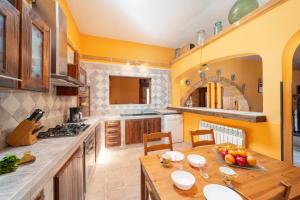 a kitchen with a wooden table and a dining room at Cas Mure in Porreres +21 photos
