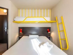 Postel nebo postele na pokoji v ubytování Greet Hotel Limoges Nord