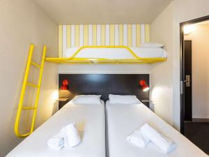 Postel nebo postele na pokoji v ubytování Greet Hotel Limoges Nord