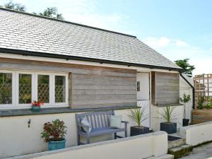 a blue chair sitting on the side of a house at Dyji in St Just