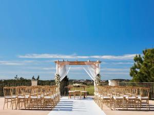 an outdoor wedding ceremony with a table and chairs at Victoria Golf Resort and Spa Managed by Accor in Vilamoura