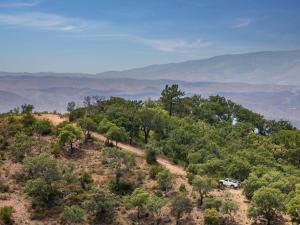 a white truck parked on a hill with trees at Victoria Golf Resort and Spa Managed by Accor in Vilamoura