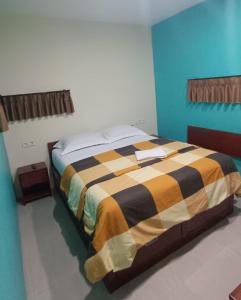 a bedroom with a bed in a blue room at Rumah Marianne in Sorong