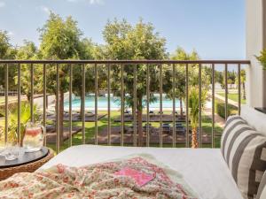 a balcony with a view of a pool at Victoria Golf Resort and Spa Managed by Accor in Vilamoura