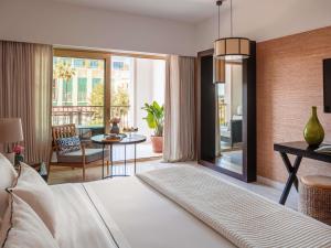 a bedroom with a bed and a living room at Victoria Golf Resort and Spa Managed by Accor in Vilamoura