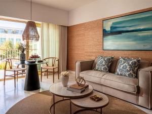a living room with a couch and a table at Victoria Golf Resort and Spa Managed by Accor in Vilamoura