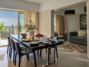 a living room with a dining room table with chairs at Victoria Golf Resort and Spa Managed by Accor in Vilamoura