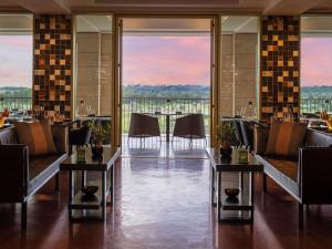 a restaurant with tables and chairs with a view at Victoria Golf Resort and Spa Managed by Accor in Vilamoura